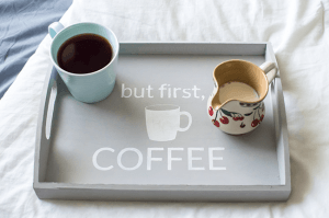 Make mornings more fun with an easy-to-make tray for your daily cup of coffee. Using chalk paint, a silhouette stencil, and an unfinished wooden tray from any craft store!