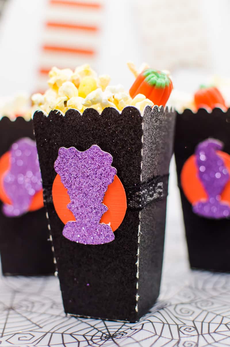 Halloween Popcorn Bags - Hocus Pocus is my favorite Halloween movie and I watch it multiple times every year. These DIY paper popcorn bags cut with my Silhouette machine are the perfect movie-watching treat bag!