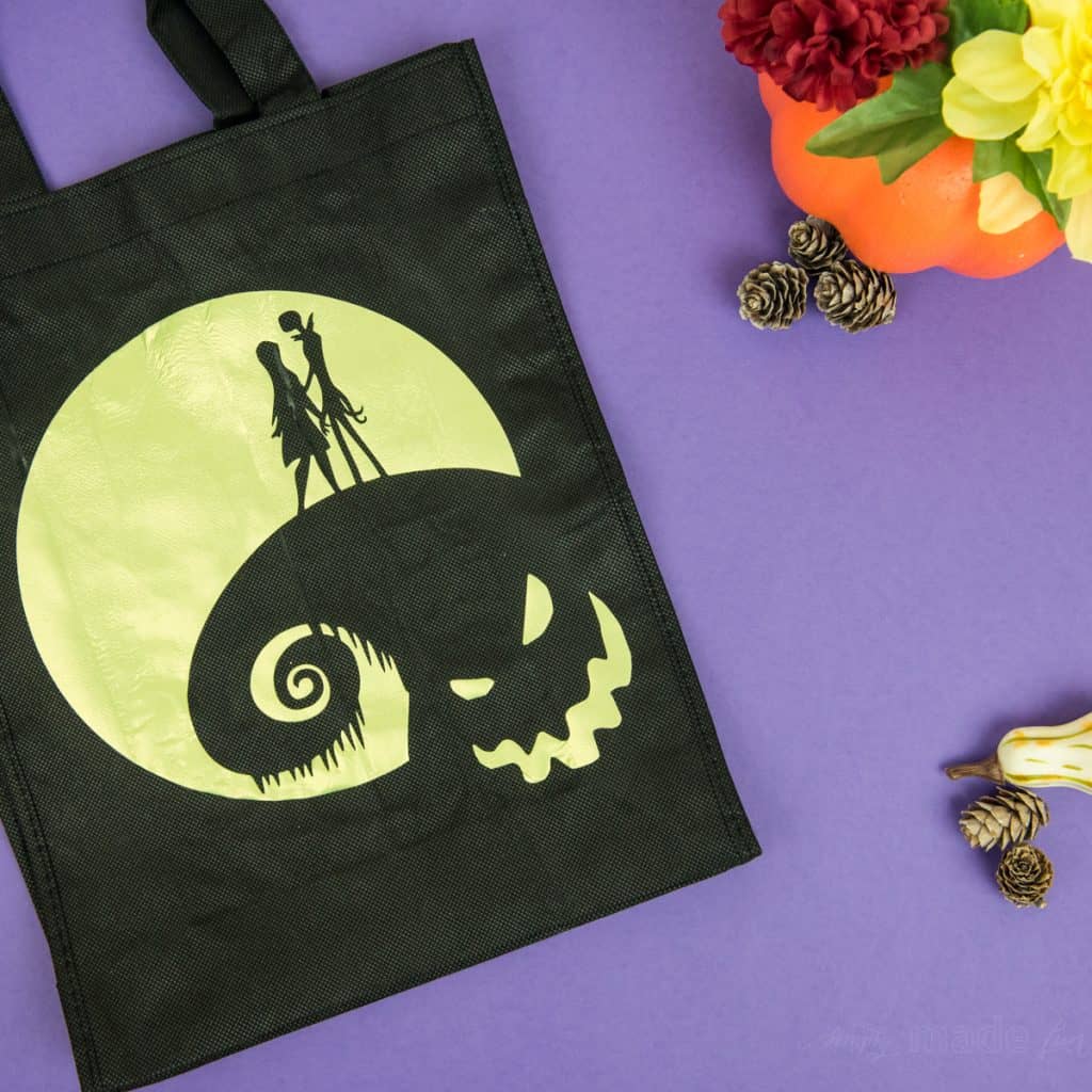Halloween Tote Bag - As a kid I always wanted my own personalized Halloween tote bag to carry my candy around in, but since that'll never happen I can at least do it for my kids! This easy Nightmare Before Halloween tote bag can be made with a Silhouette or Cricut machine. It's so spooky, even the parents will want one of their own.