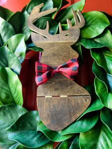 Make the easiest holiday wreath to last through Christmas and beyond! All it takes is a little bit of greenery, wood, and the perfect buffalo plaid ribbon to give your front door a little holiday style.