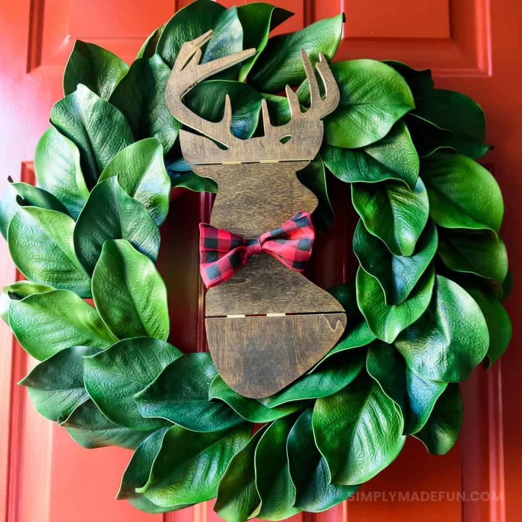 Make the easiest holiday wreath to last through Christmas and beyond! All it takes is a little bit of greenery, wood, and the perfect buffalo plaid ribbon to give your front door a little holiday style.