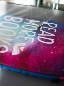 Removing the htv carrier sheet after using your heat press to put the decal on the book sleeve