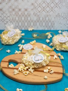 gender neutral baby shower gift tags tied to bags of fresh popcorn
